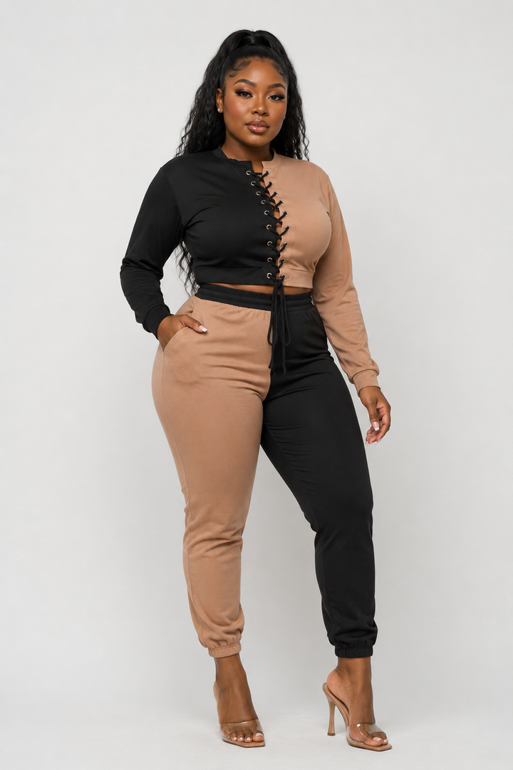 Colorblock lace-up crop top and jogger set in black and mocha — front view